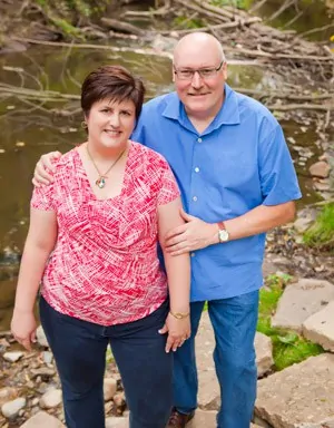 woman and m an in front of river