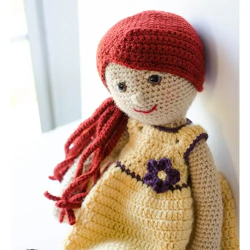 crochet doll with orange hair and yellow dress