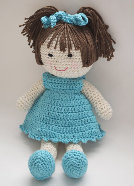 Crochet doll with dark hair and blue dress