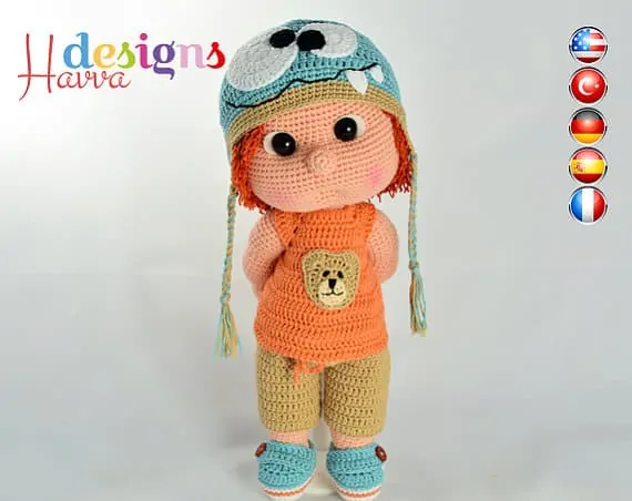 Crochet doll with monster hat, orange shirt and green pants