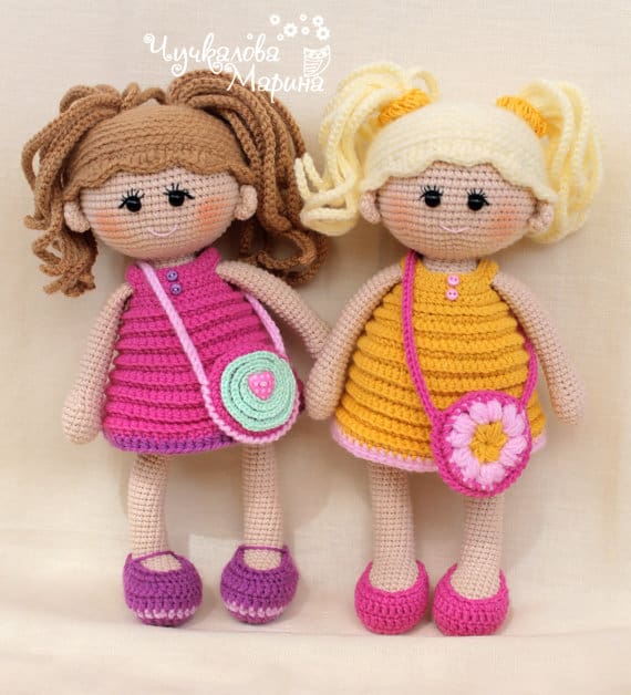 Two crochet dolls with pigtails and brightly colored dresses