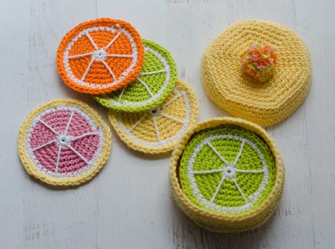 Citrus costers in a yellow crochet box.