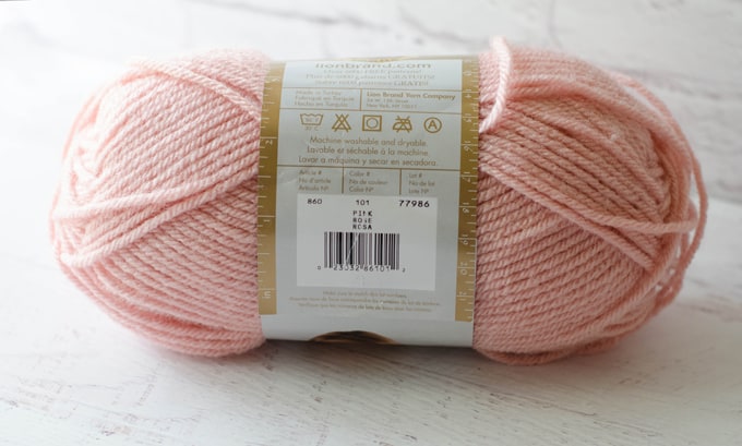 Skein of pink yarn showing manufacturer label information