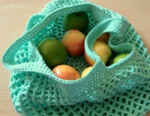 Green crochet market bag with fruit