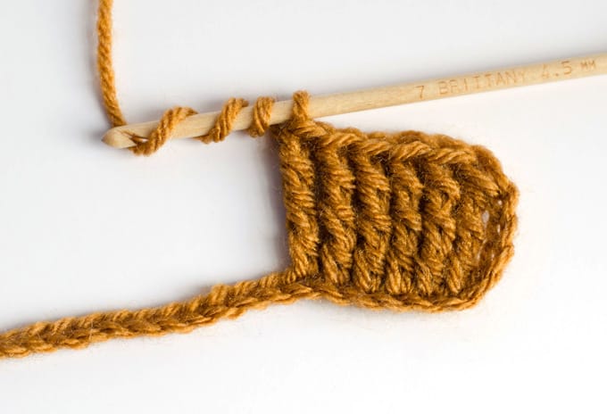 double treble crochet sample with gold yarn and wood hook