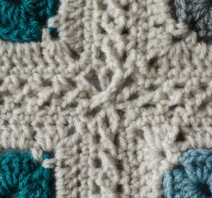 Crochet afghan squares in cream, blue and gray yarn