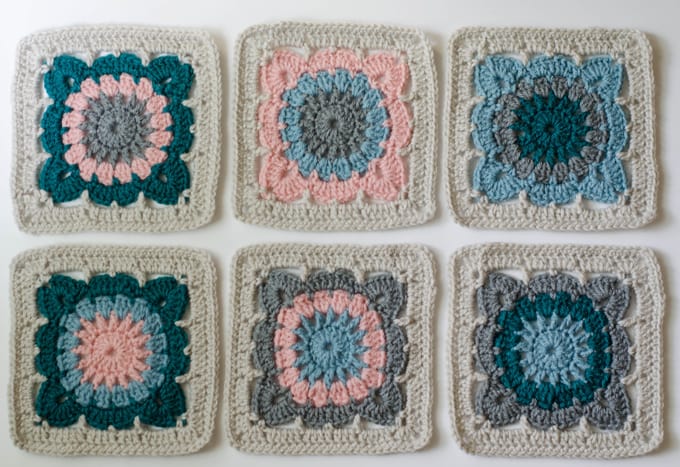 multiple crochet afghan squares in blue, pink, gray and ivory