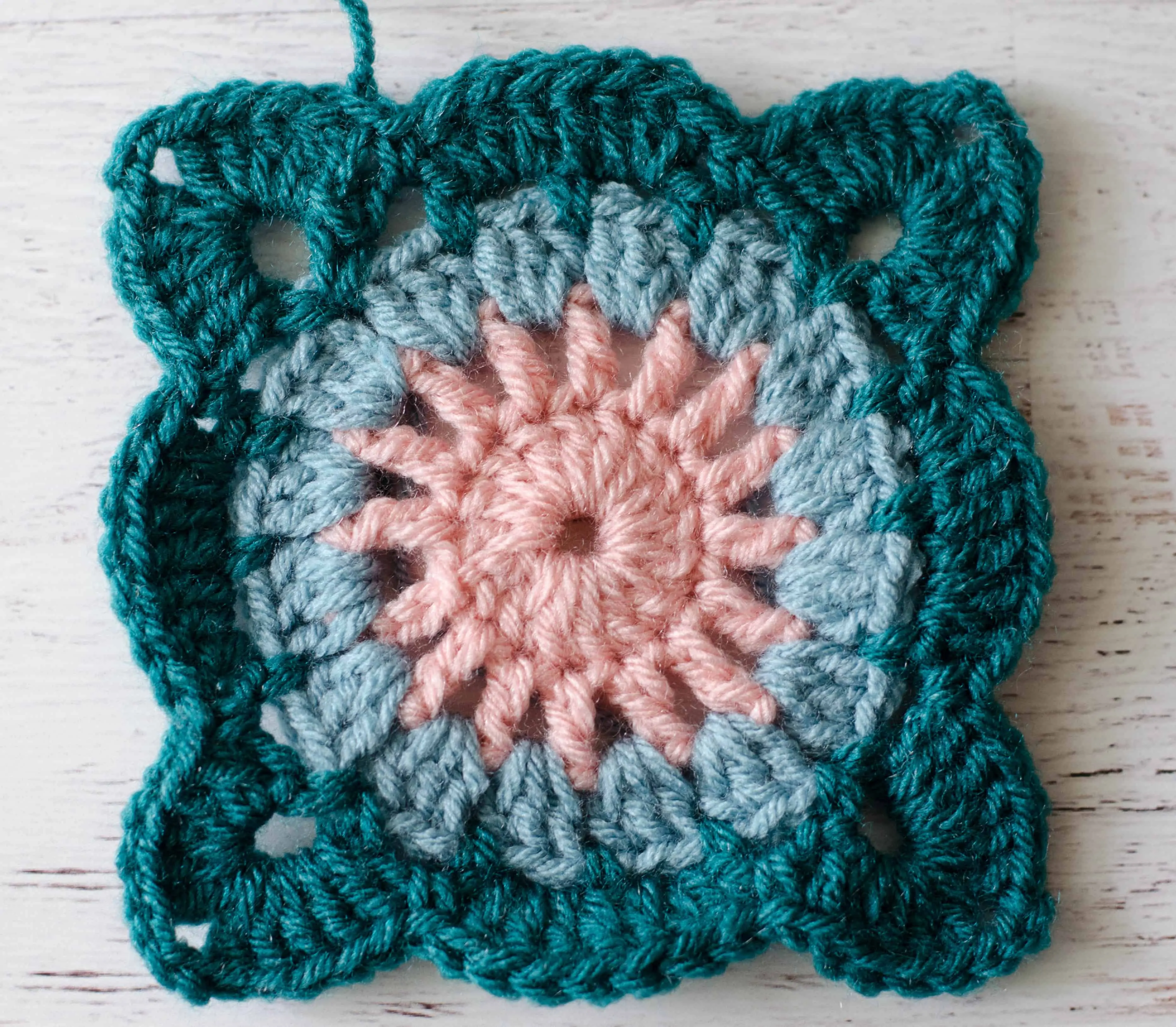 Crochet motif in pink, blue and teal
