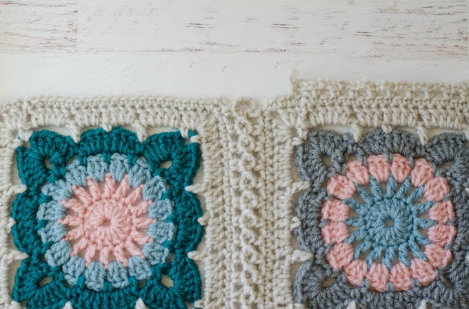 Crochet afghan squares in cream, blue and gray yarn