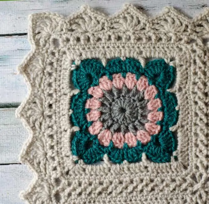 Corner of crochet afghan with scalloped crochet border