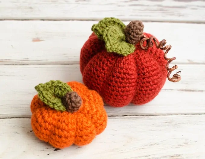 small orange crochet pumpkin and medium dark orange crochet pumpkin