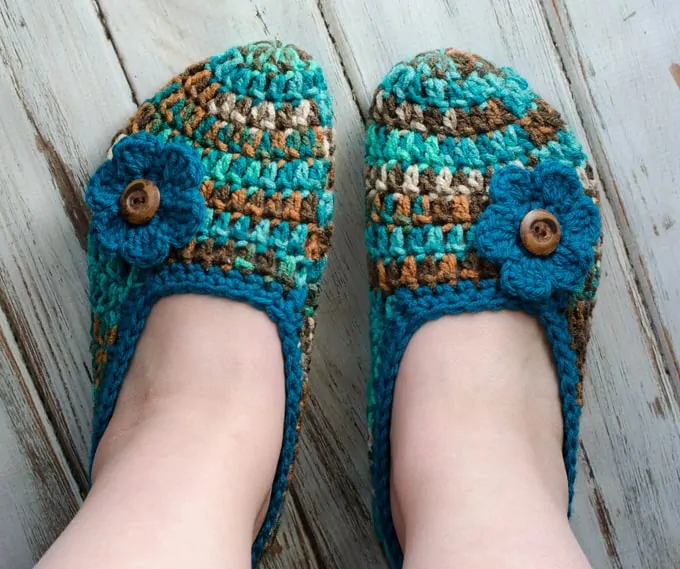 blue and green slippers on woman's feet