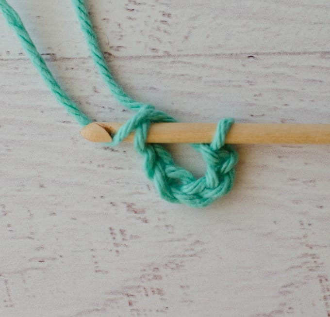 Joining a crochet chain in green yarn with wood hook
