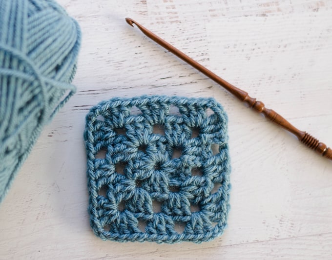 Completed Blue Granny Square with wooden hook