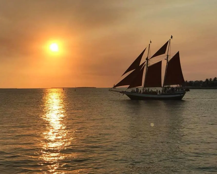 sailboat at sunset on lake