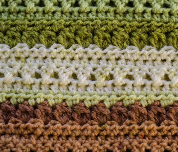 Close up of green, brown and cream crochet afghan stitches