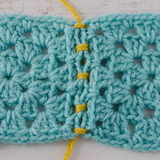 Crochet Faux Braid Join of blue granny squares with yellow yarn