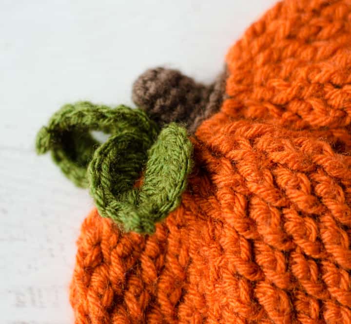 Up close view of crochet leaves and stem on crochet pumpkin hat