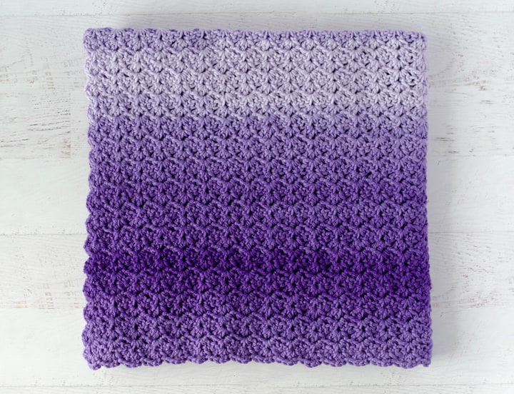 Folded purple Tulip Stitch Crochet Baby Afghan