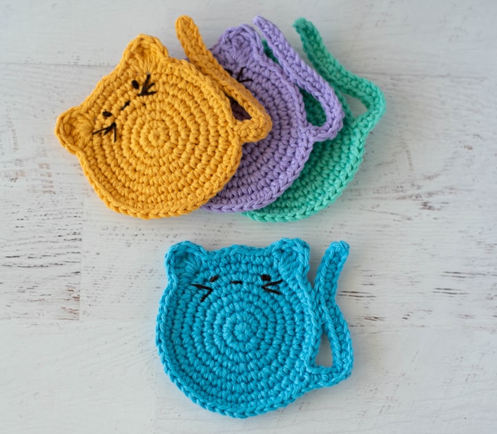 crochet cat coasters with embroidered features