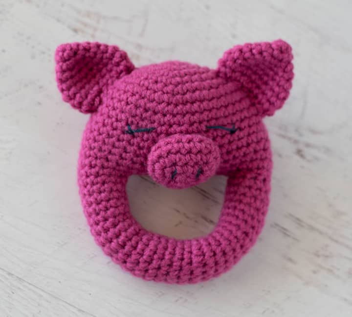 crochet pig rattle with sleepy looking eyes