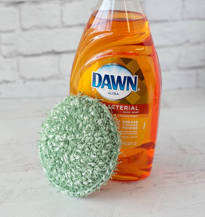 green crochet dish scrubber with Dawn Dish soap