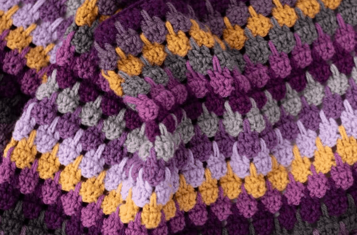 crochet stitch pattern in jewel tone yarn
