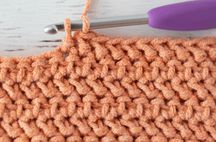 crochet stitch pattern in orange yarn