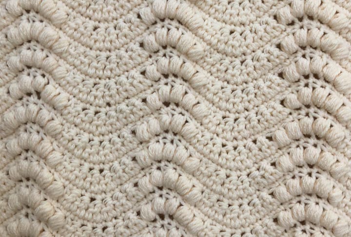 Up close stitches on ivory crochet wallhanging