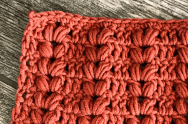 Crochet stitch sample with rust color yarn