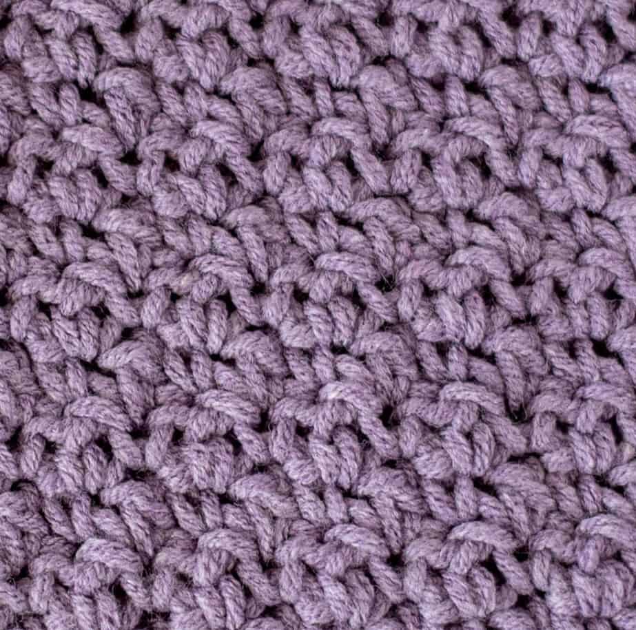 up close view of crochet soft moss stitch with purple yarn