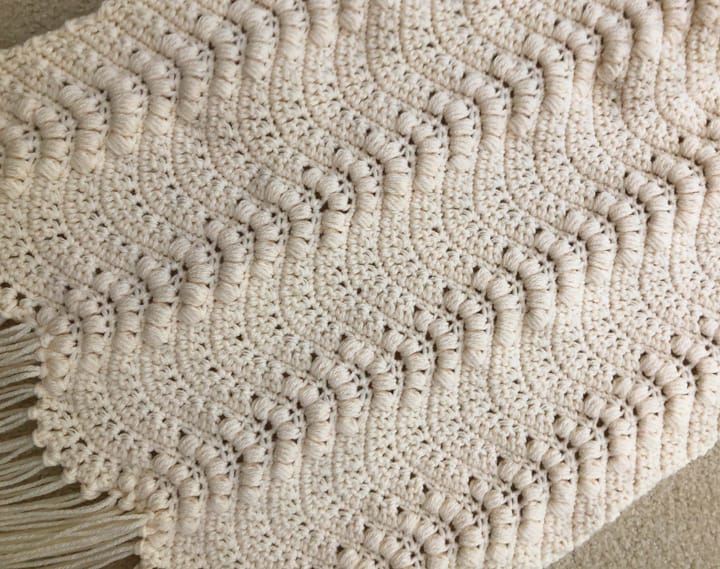 Up close stitches on ivory crochet wallhanging