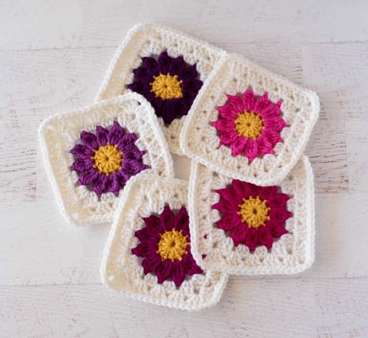 crochet flower granny squares in pinks and purples