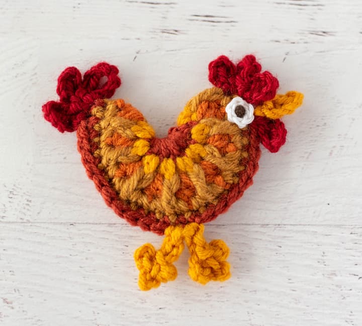 crochet rooster in orange, red and yellow yarn