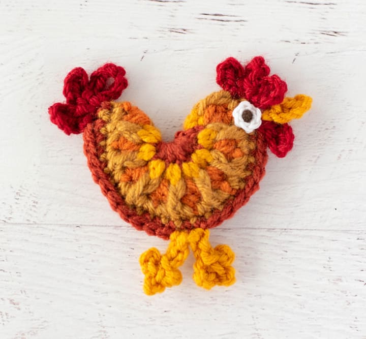 crochet rooster in orange, red and yellow yarn