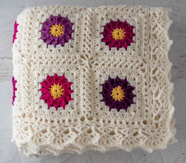 folded crochet afghan with lacy border