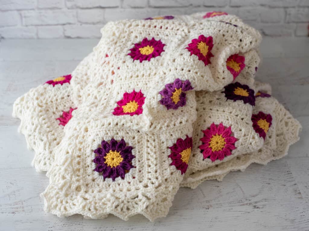off white and vibrant pink and purple crochet afghan