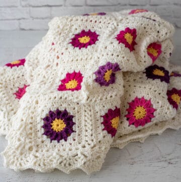 off white and vibrant pink and purple crochet afghan