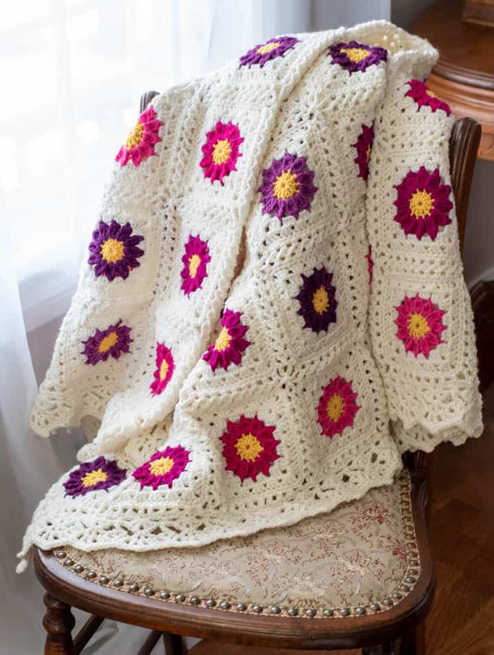 pink and purple and white granny square lacy crochet flower blanket