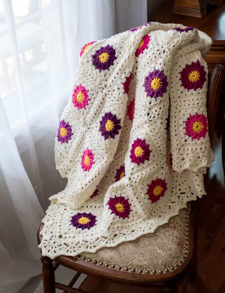 pink and purple and white granny square lacy crochet flower blanket