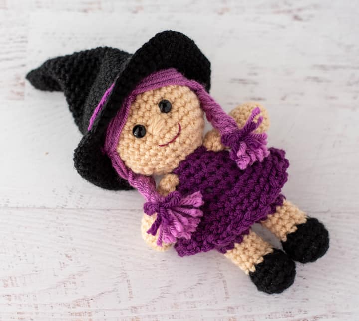 pink and purple crochet witch with black hat and shoes