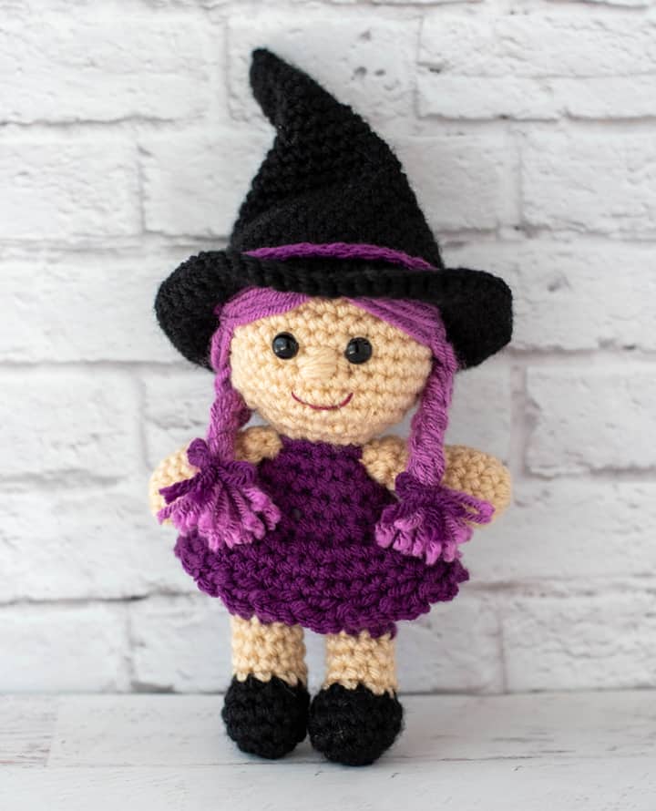 pink and purple crochet witch with black hat and shoes