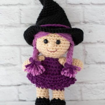 pink and purple crochet witch with black hat and shoes