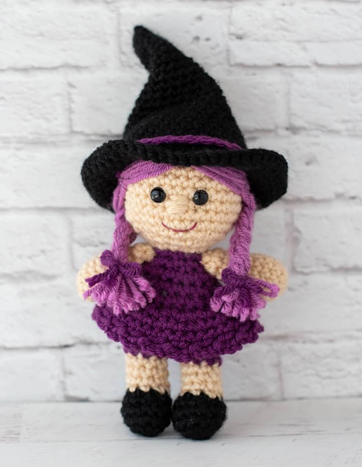 pink and purple crochet witch with black hat and shoes