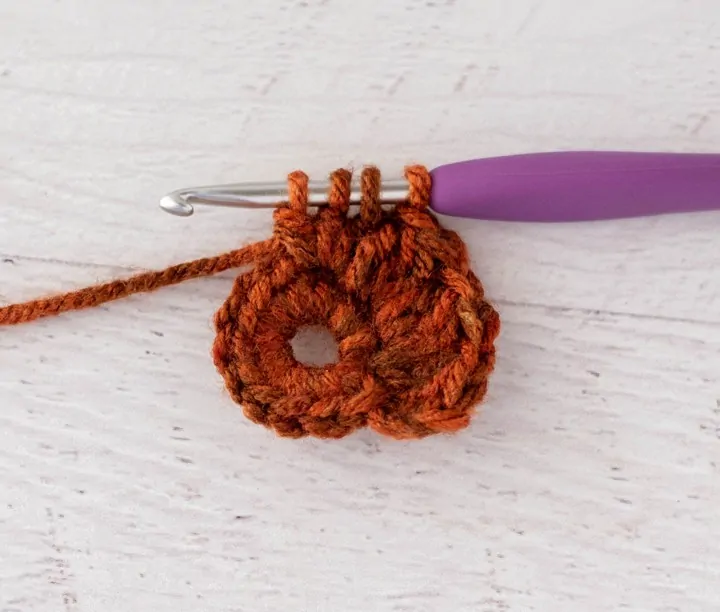 crochet cluster stitch out of orange yarn