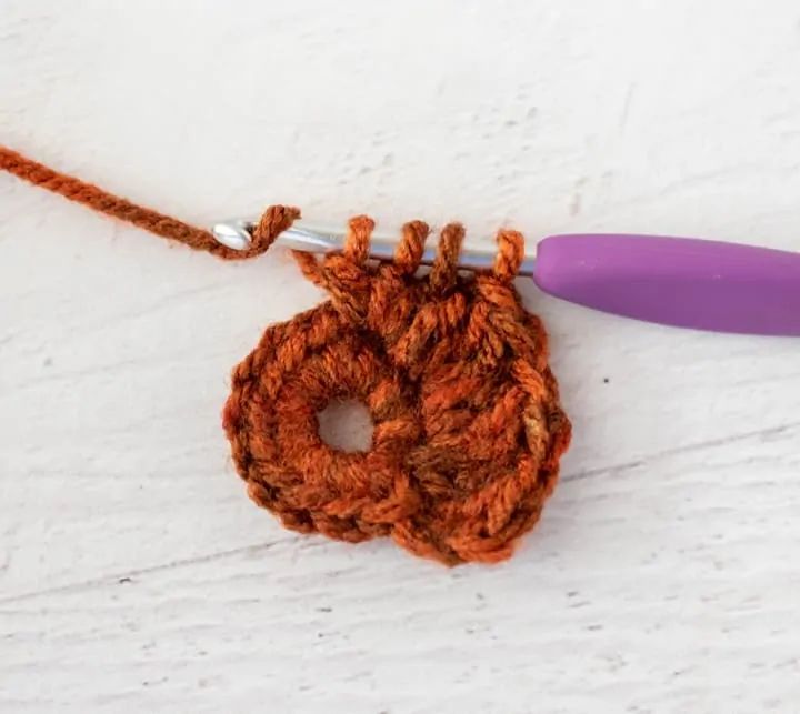 crochet cluster stitch out of orange yarn