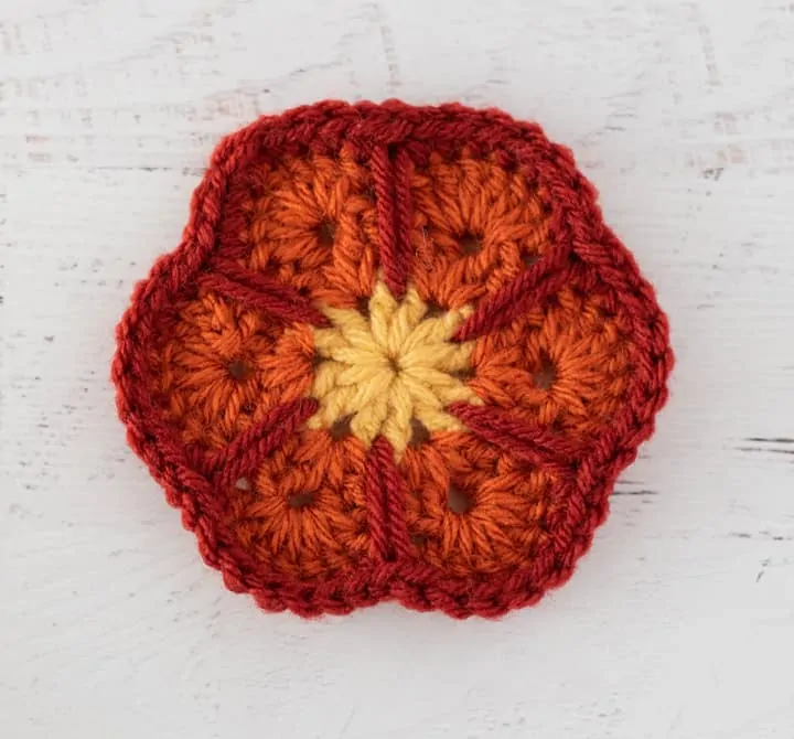 crochet african flower motif in yellow, orange and rust