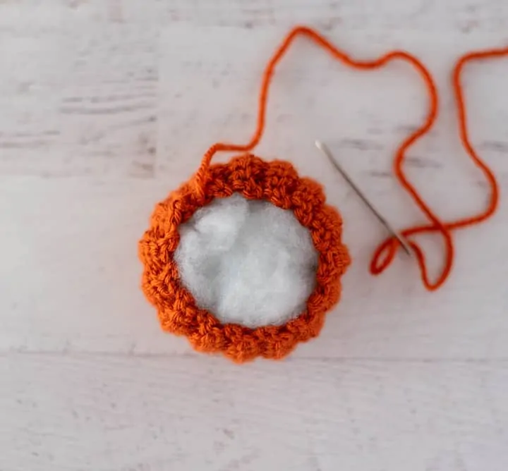 top of crochet pumpkin during assembly