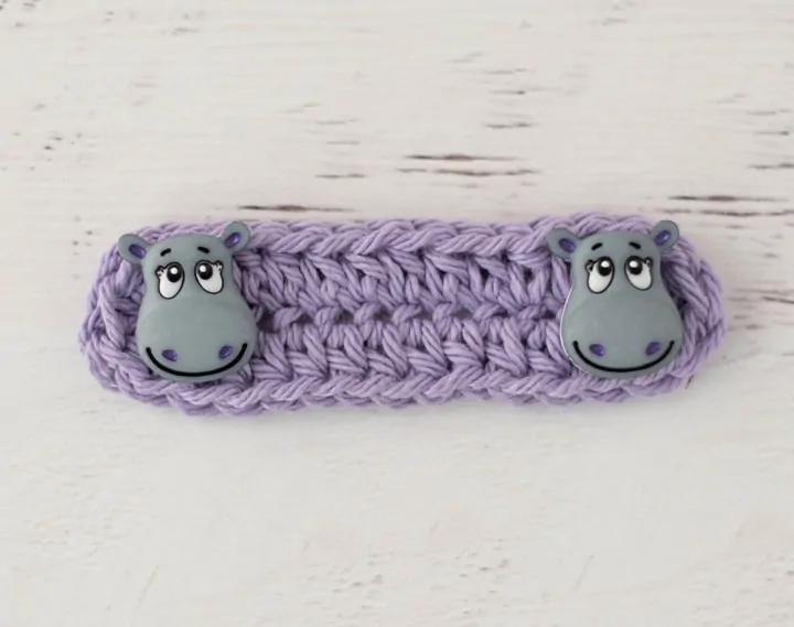 Purple crochet ear saver with hippo button