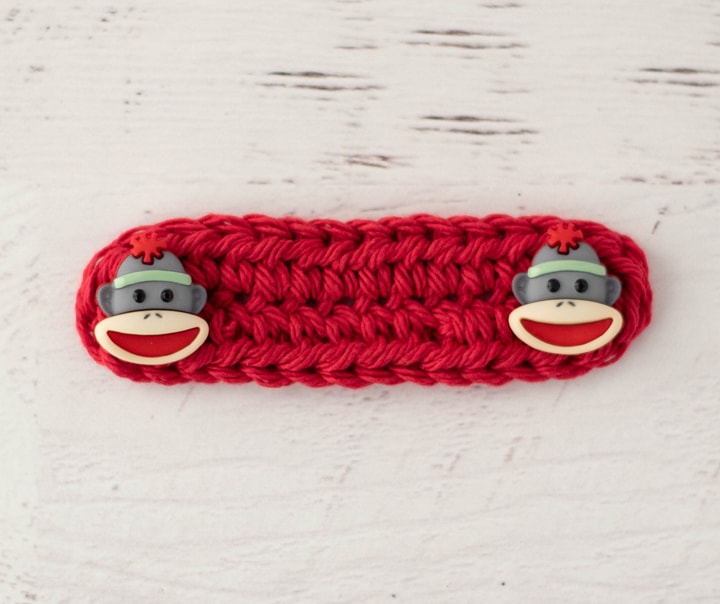 Crochet red Ear saver with monkey buttons